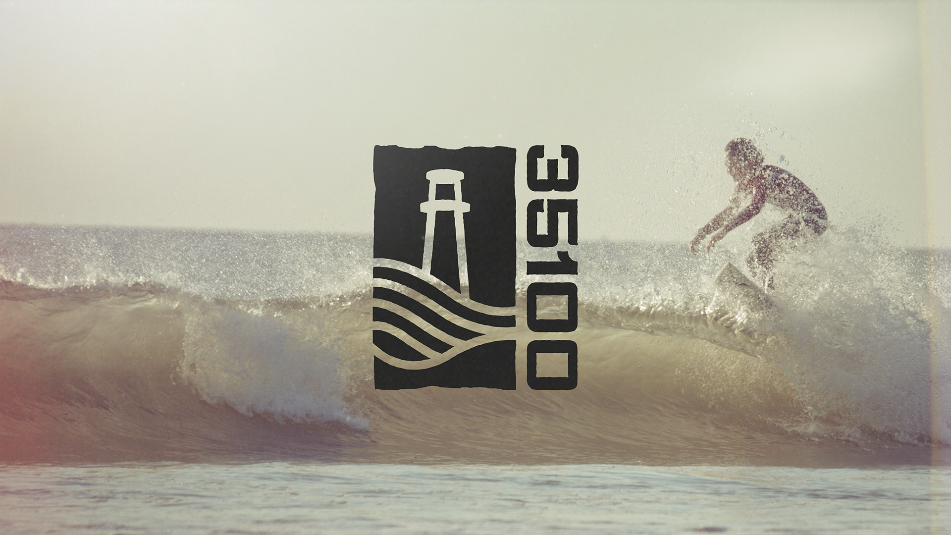 35100 logo featuring a lighthouse and waves over a surfer riding a wave