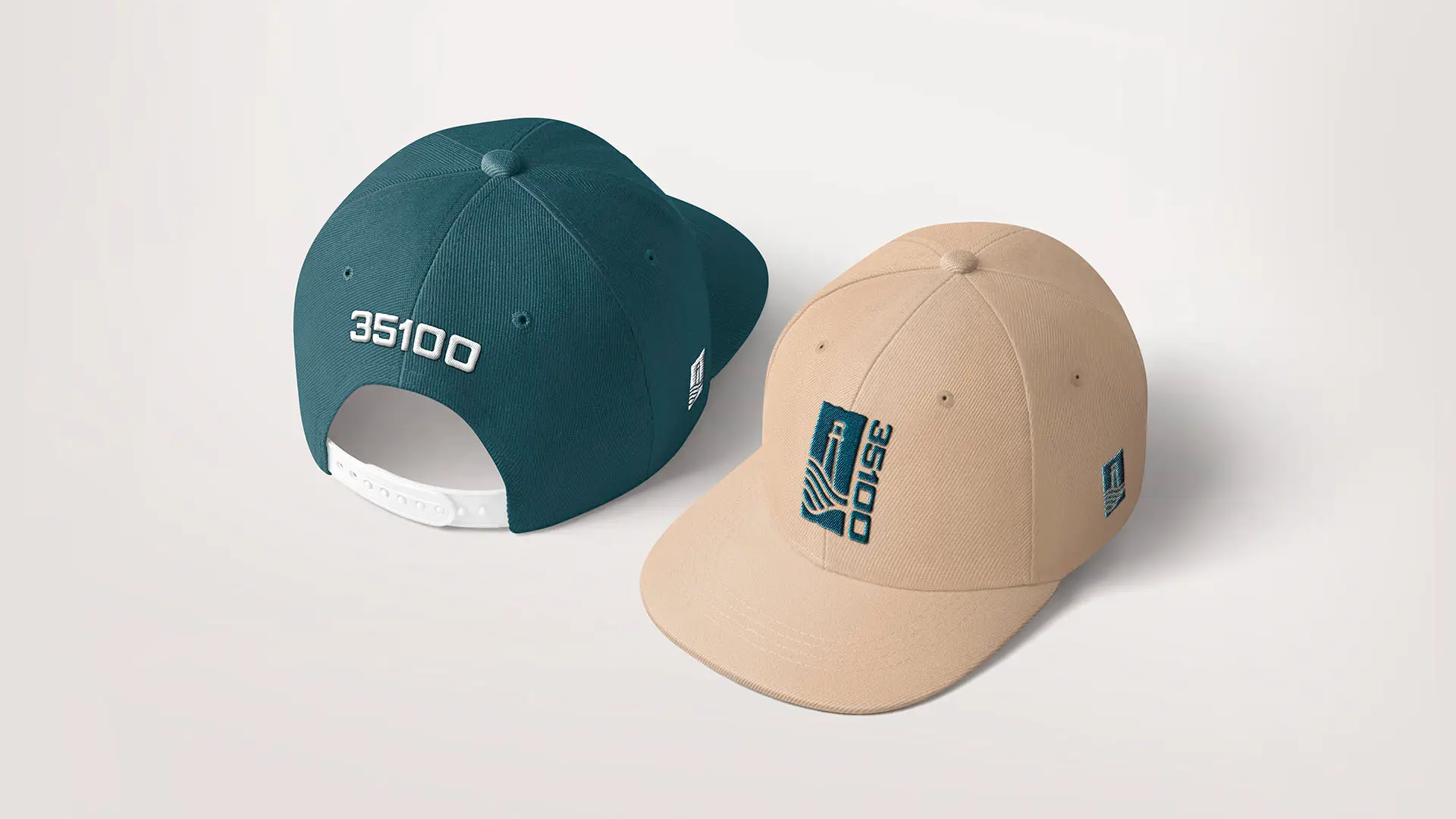 Two 35100-branded snapback hats: a teal cap showing the back with embroidered "35100," and a tan cap showing the front logo