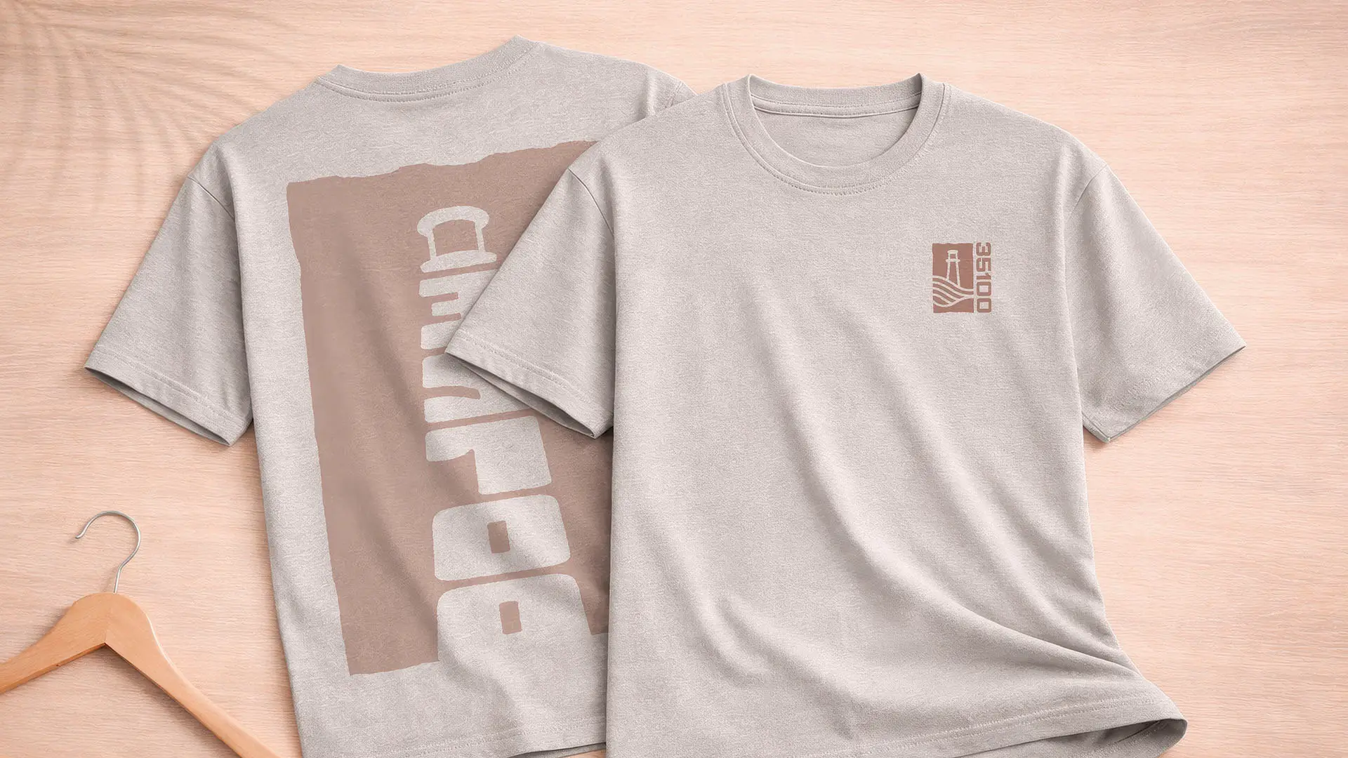 Front and back view of a gray t-shirt with a tan 35100 lighthouse logo on the chest and large vertical graphic on the back