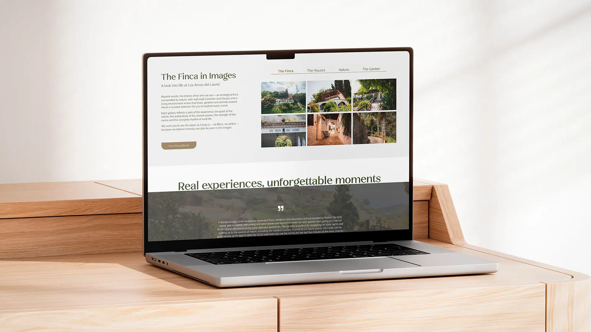 Laptop displaying the Los Arcos del Laurel finca website, showing a photo gallery and guest testimonials section